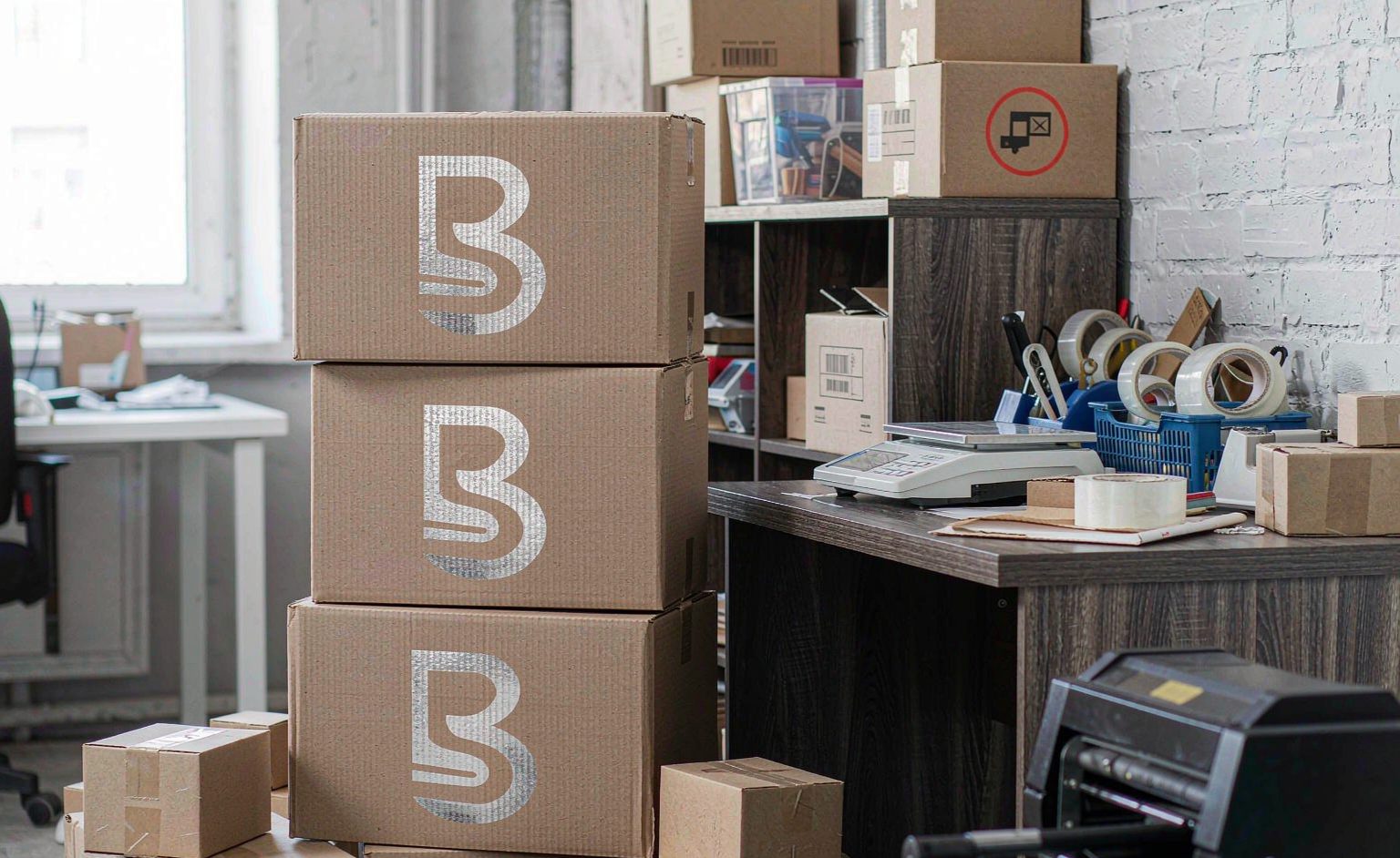Stack of custom branded shipping boxes in an e-commerce packing area