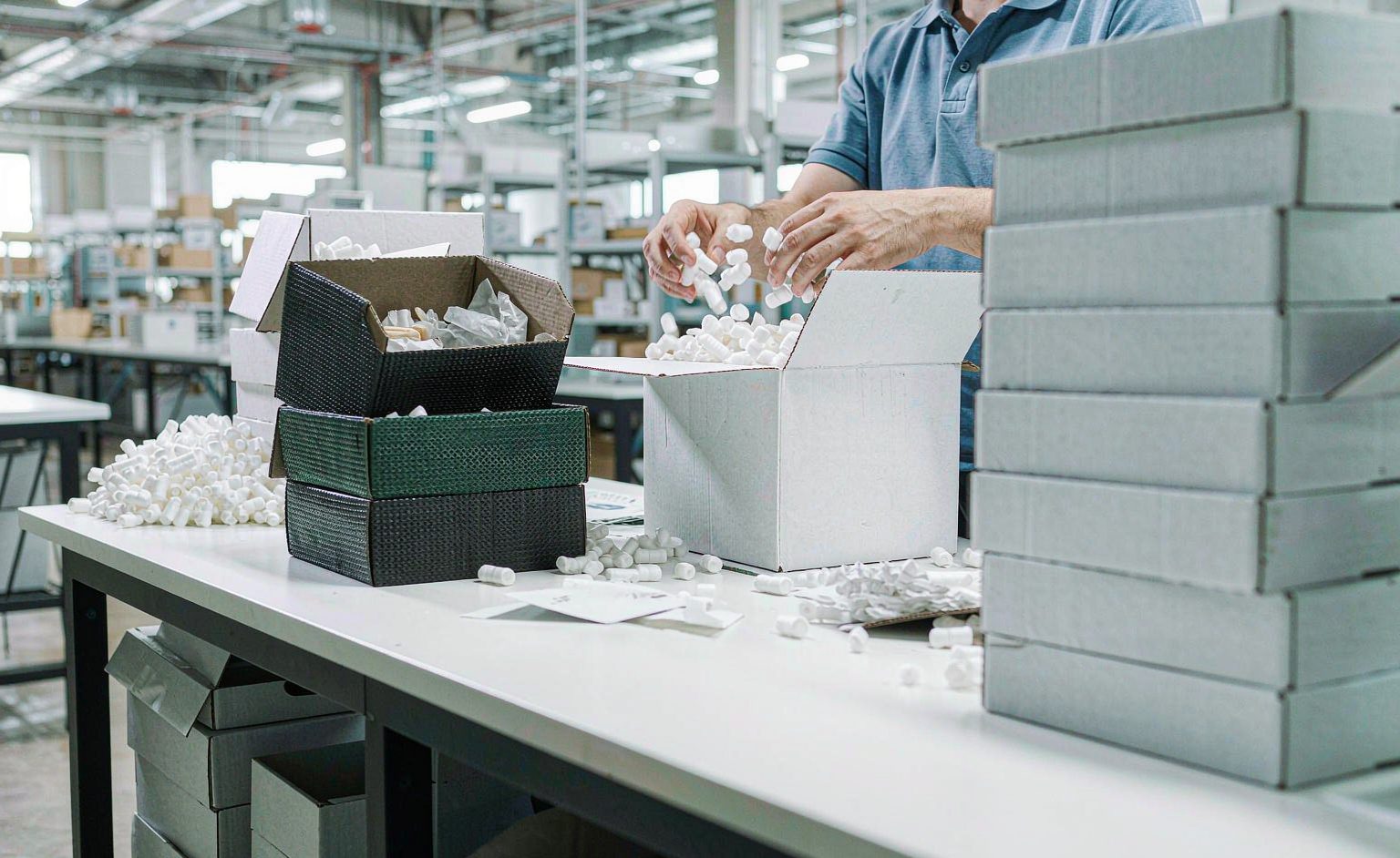 E-commerce fulfillment worker packing orders with shipping labels at a warehouse